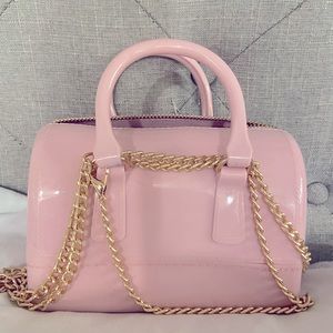Mini Pink purse. Gold zip closure. Gold chain removable strap and pink handles.